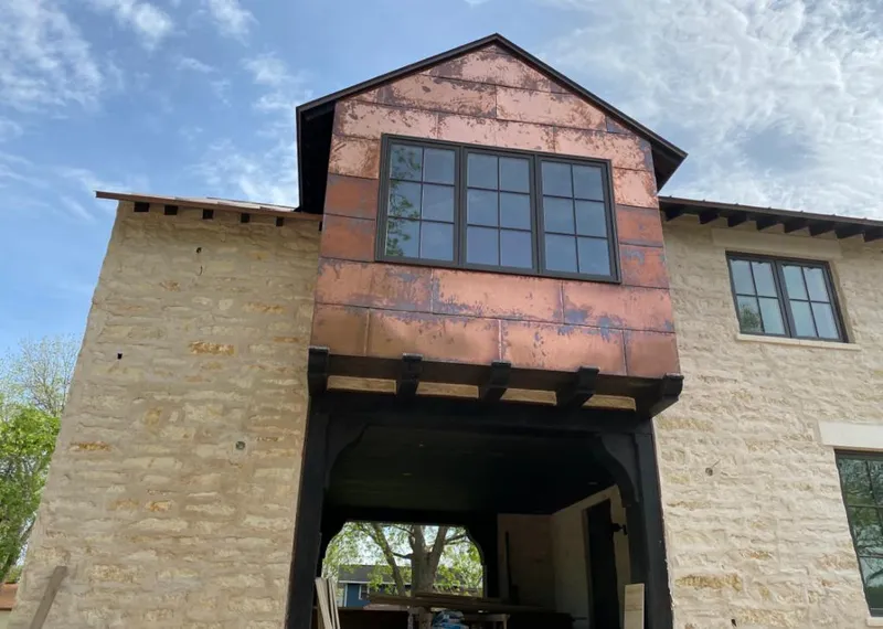 Copper metal panel facade on a stone building for Roof Repair in Pleasant Hills